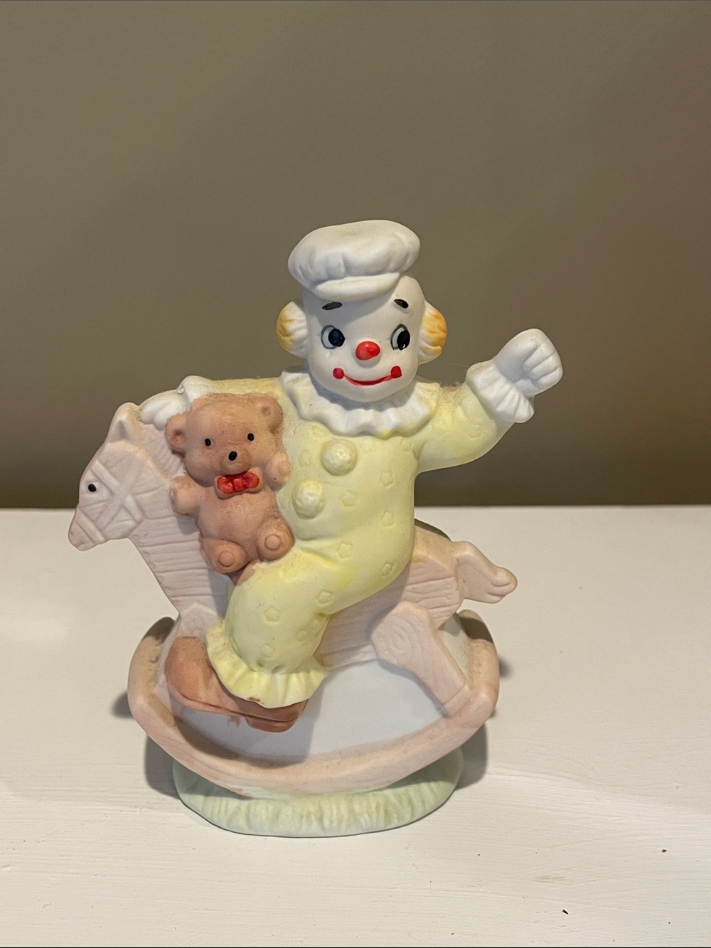 Clown figurine riding  rocking horse